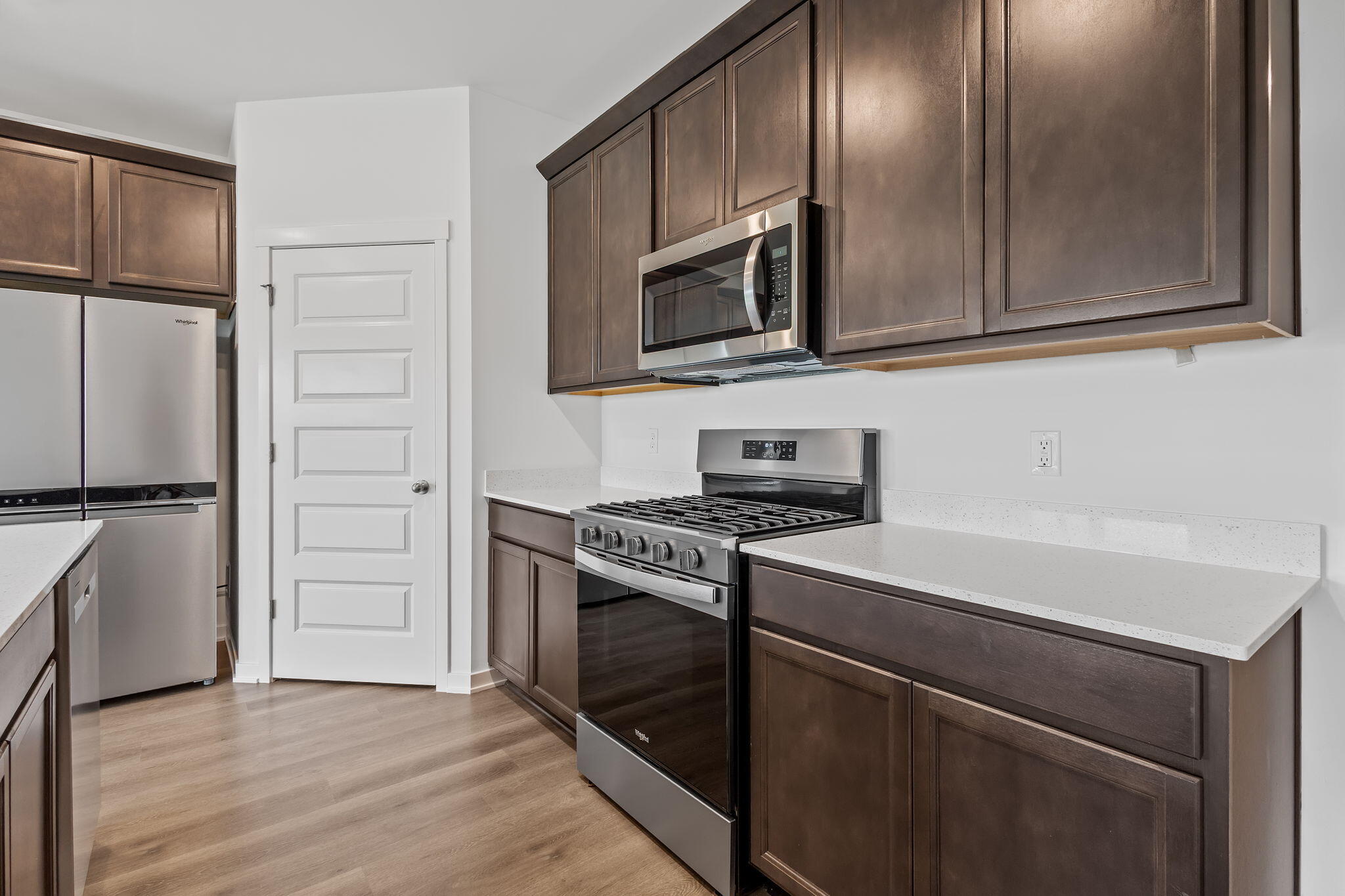 7293 West 107th Place Crown Point, IN 46307 - Photo 2 of 24 a kitchen with cabinets stainless steel appliances and wooden floor