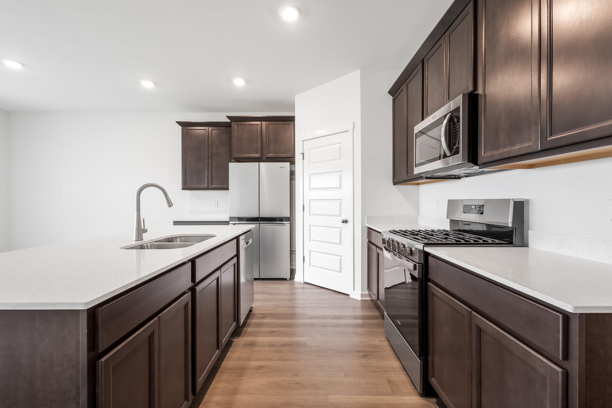 7293 West 107th Place Crown Point, IN 46307 - Photo 4 of 24 a kitchen with stainless steel appliances granite countertop a sink stove oven and refrigerator