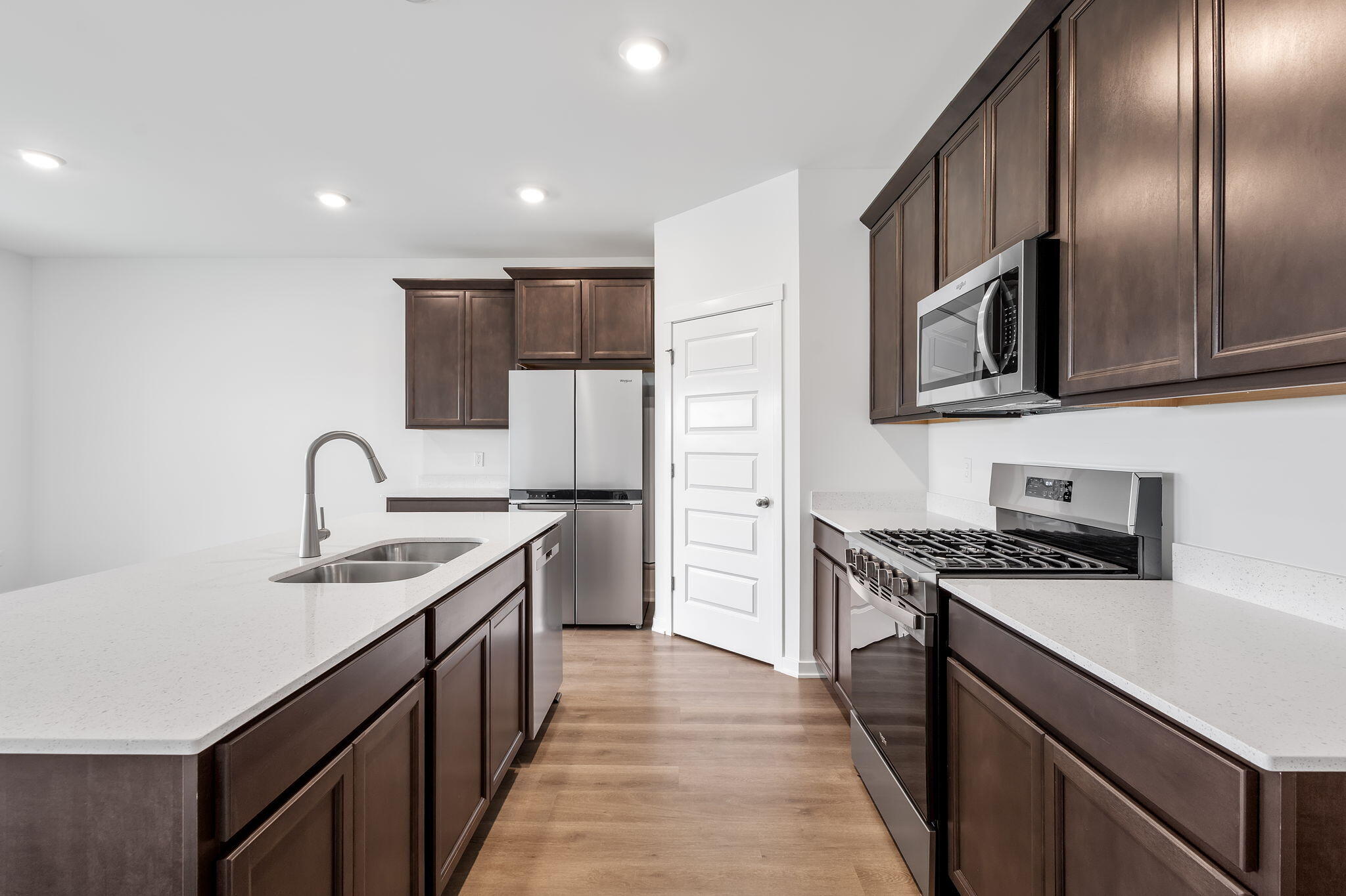 7293 West 107th Place Crown Point, IN 46307 - Photo 5 of 24 a kitchen with stainless steel appliances granite countertop a sink stove oven and refrigerator