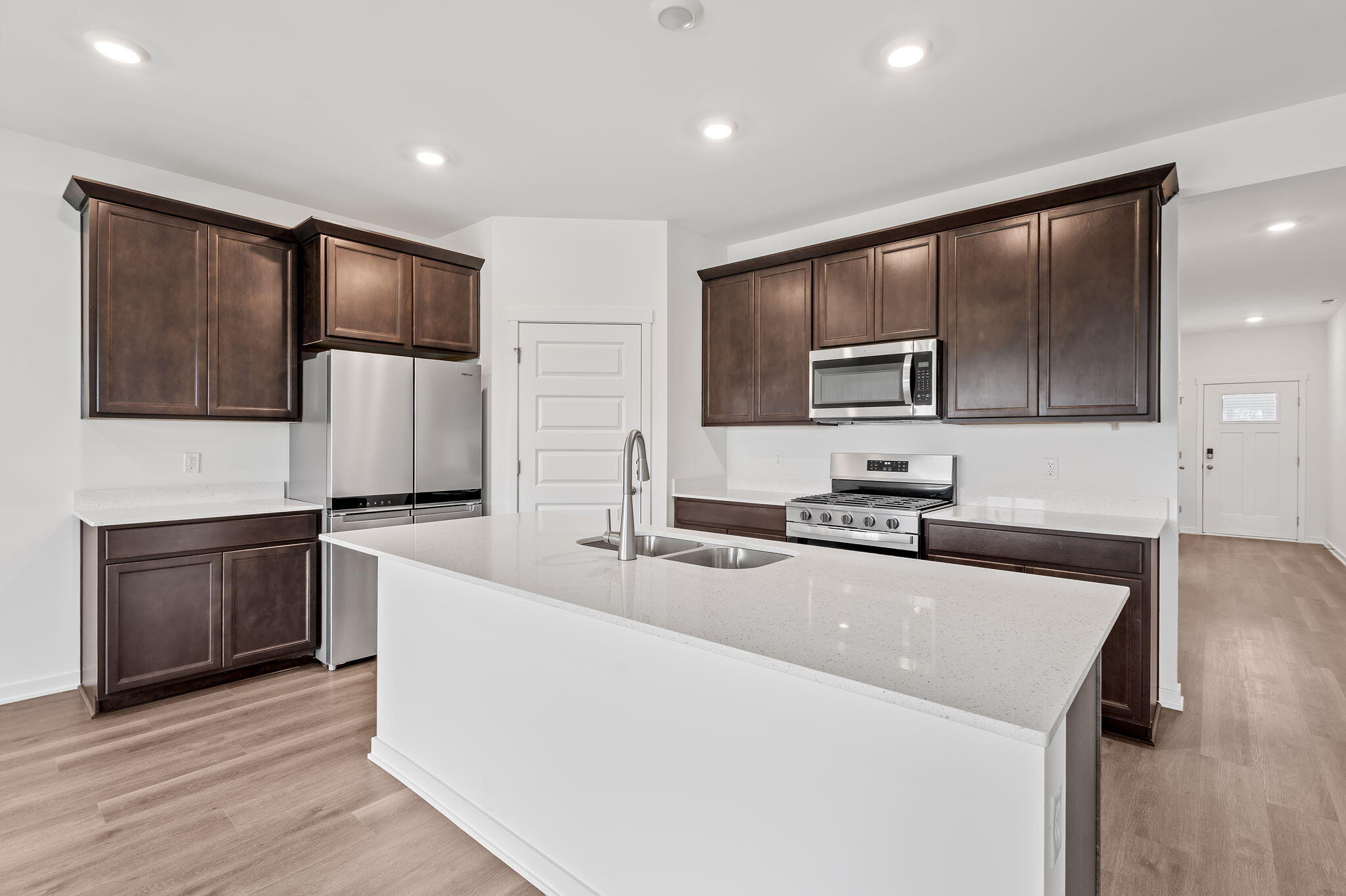 7293 West 107th Place Crown Point, IN 46307 - Photo 7 of 24 a kitchen with stainless steel appliances wooden cabinets and a counter top space