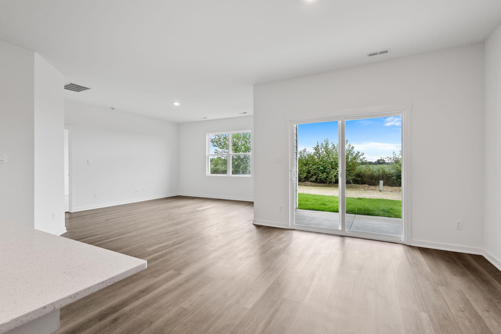 7293 West 107th Place Crown Point, IN 46307 - Photo 9 of 24 an empty room with wooden floor and windows
