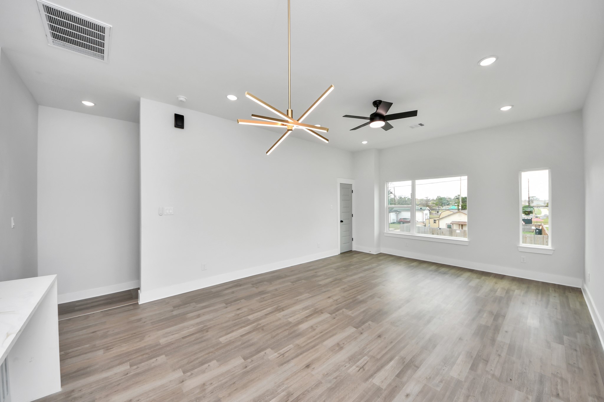 8114 Double Avenue, Unit B Houston, TX 77088 - Photo 11 of 34 wooden floor in an empty room with a window