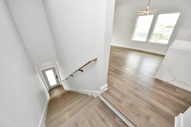 a view of entryway and hall with wooden floor