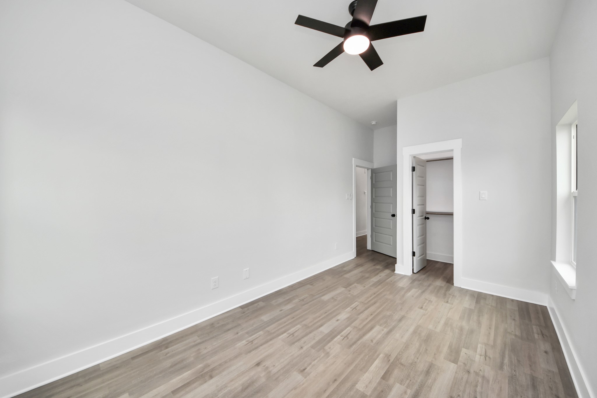 8114 Double Avenue, Unit B Houston, TX 77088 - Photo 21 of 34 a view of a room with wooden floor and ceiling fan