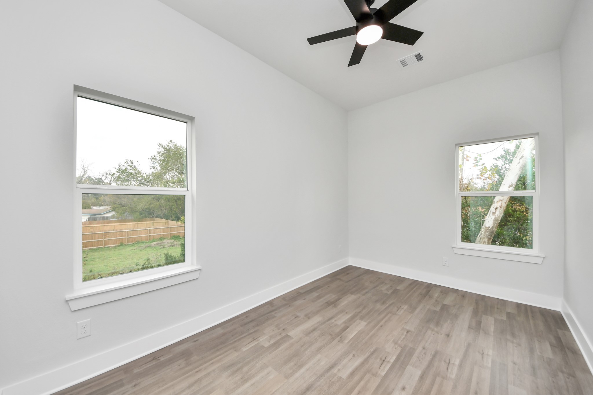 8114 Double Avenue, Unit B Houston, TX 77088 - Photo 22 of 34 a view of an empty room with wooden floor and a window