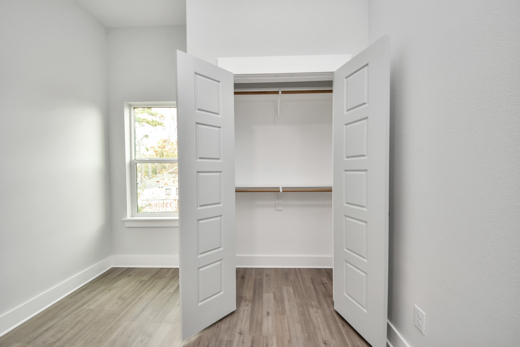 8114 Double Avenue, Unit B Houston, TX 77088 - Photo 27 of 34 an empty room with wooden floor closet and windows