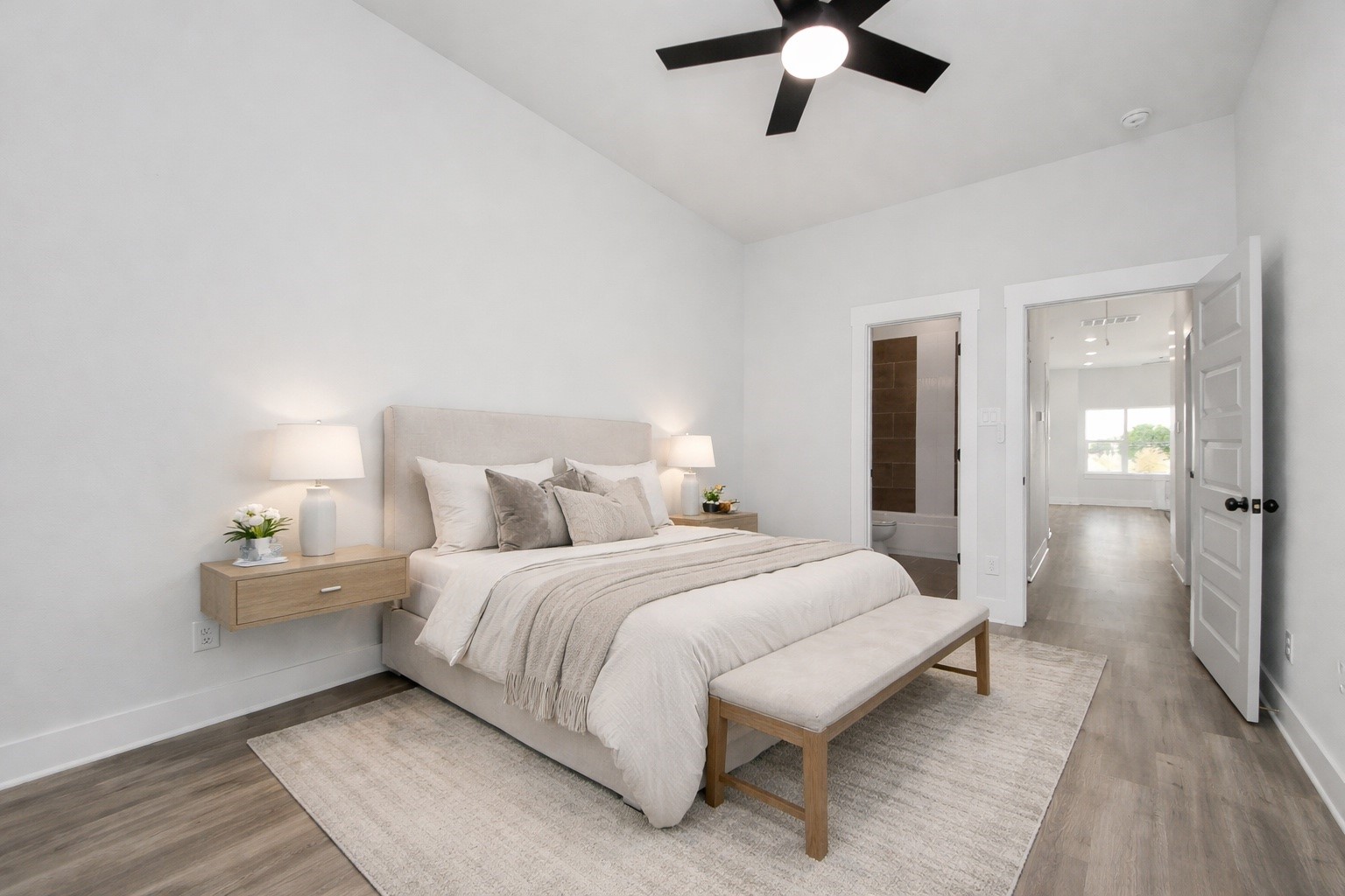 8114 Double Avenue, Unit B Houston, TX 77088 - Photo 3 of 34 a bedroom with a bed and a chandelier