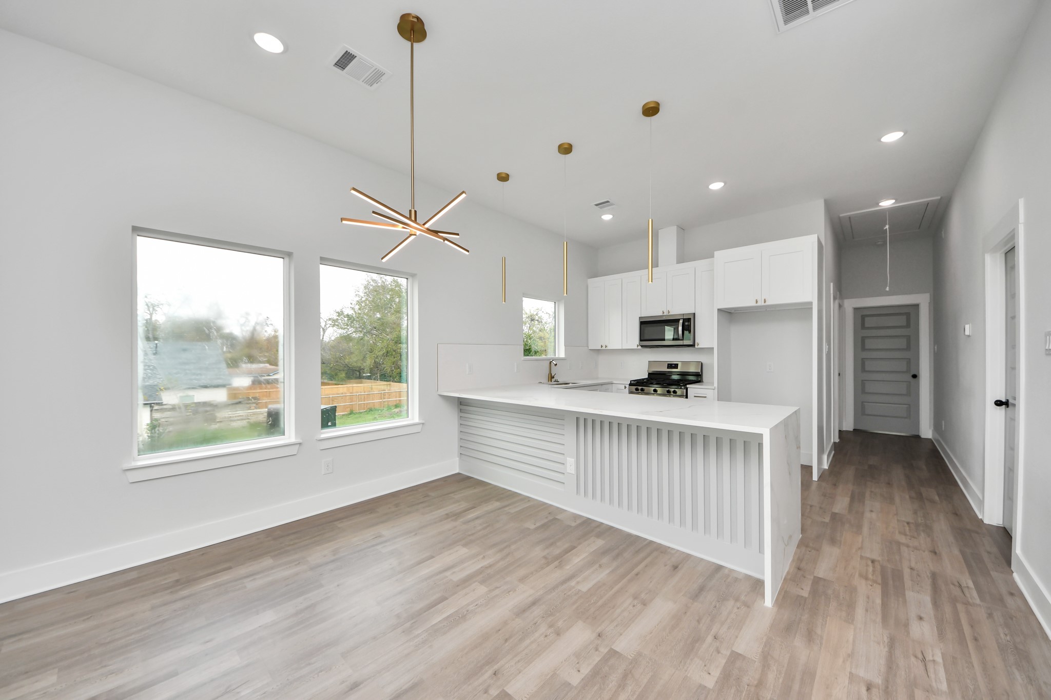 8114 Double Avenue, Unit B Houston, TX 77088 - Photo 9 of 34 a kitchen with stainless steel appliances granite countertop a refrigerator a sink dishwasher a stove and white countertops with wooden floor