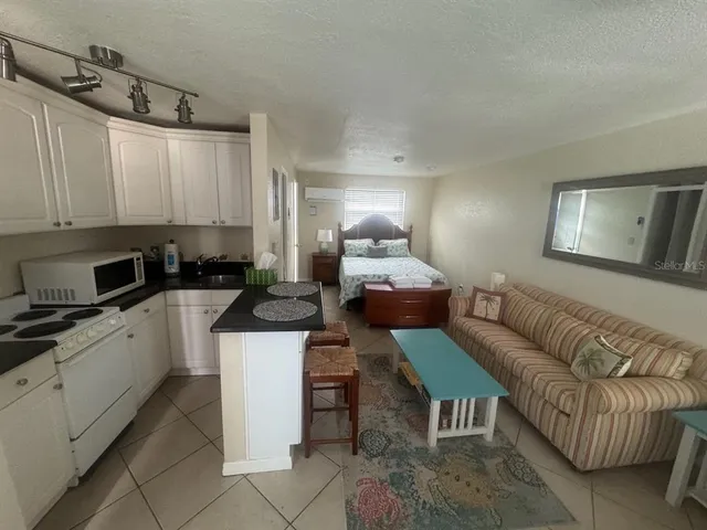 a kitchen with a refrigerator and a stove top oven