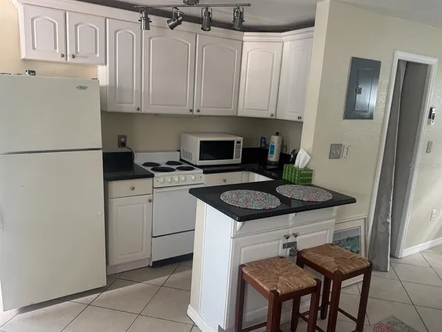 a kitchen with stainless steel appliances granite countertop a stove a refrigerator and a refrigerator