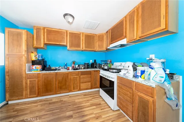 a kitchen with stainless steel appliances granite countertop a sink dishwasher stove and refrigerator