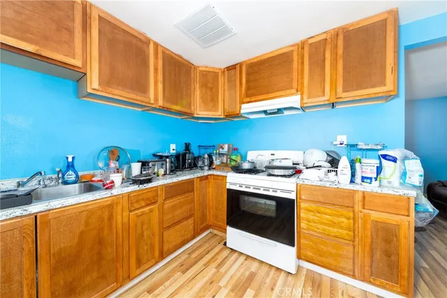 a kitchen with stainless steel appliances granite countertop a sink stove and cabinets