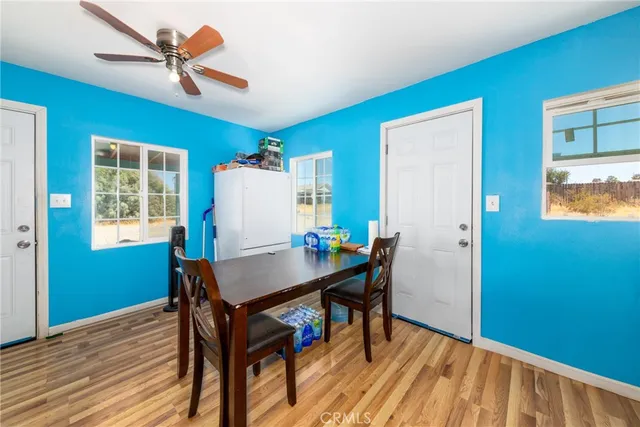 a view of a workspace with furniture and a table