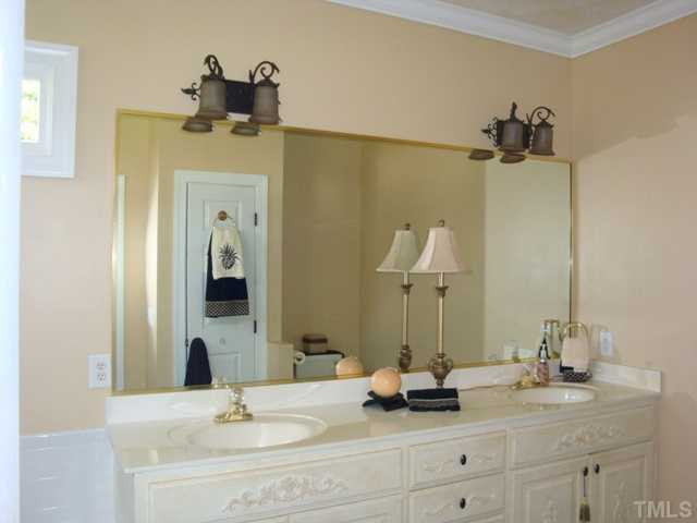 2845 Anfield Road Raleigh, NC 27606 - Photo 10 of 25 Crown Molding and Two-Transom Windows Enhance the Tiled Master Bath with Dual Vanity, Linen Closet, Jacuzzi Garden Tub and Separate Shower Master Bath/Spa