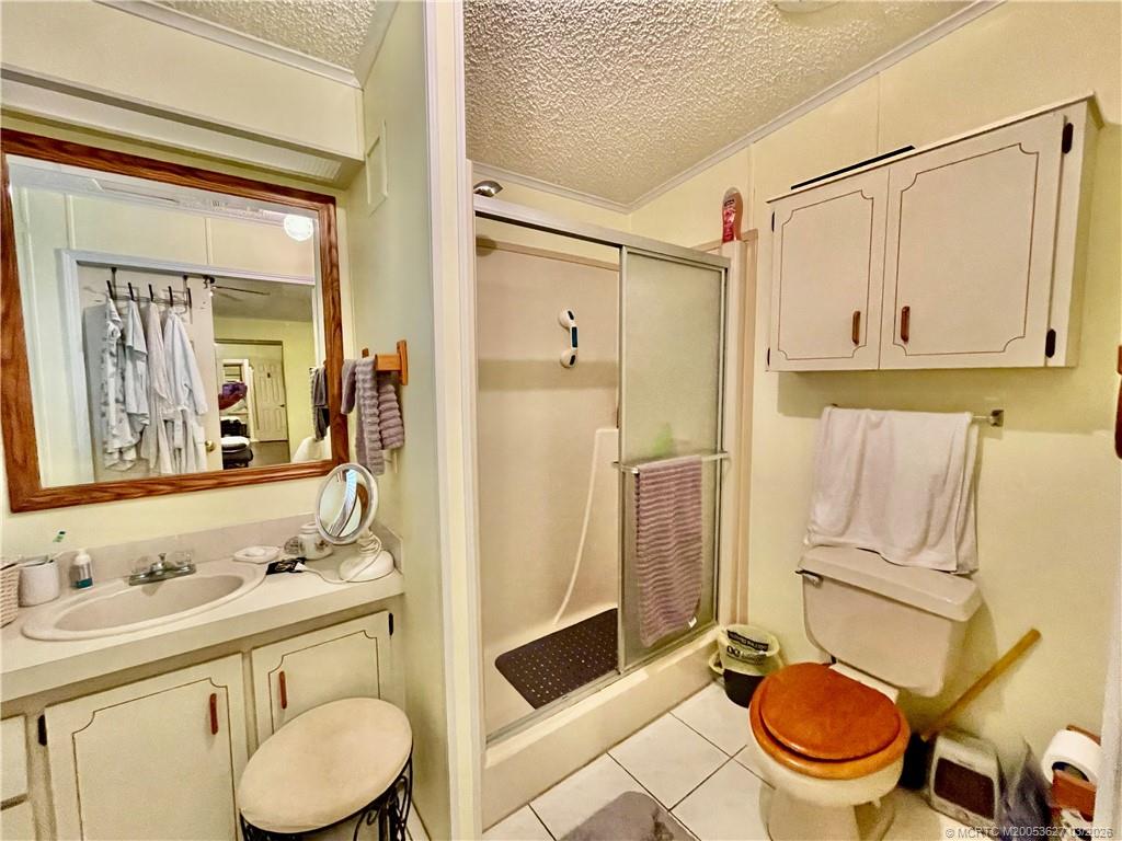 14524 Southwest Rake Drive Indiantown, FL 34956 - Photo 19 of 24 a bathroom with a granite countertop toilet sink and mirror