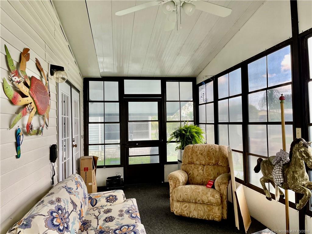 14524 Southwest Rake Drive Indiantown, FL 34956 - Photo 2 of 24 a living room with furniture and a floor to ceiling window