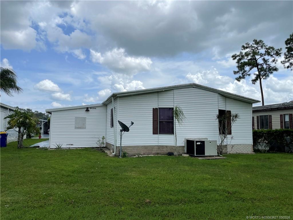 14524 Southwest Rake Drive Indiantown, FL 34956 - Photo 24 of 24 a house view with a garden space and wooden fence