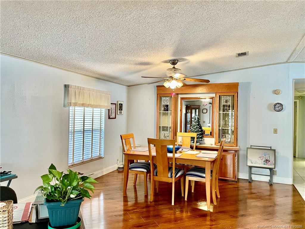 14524 Southwest Rake Drive Indiantown, FL 34956 - Photo 5 of 24 a view of a dining room with furniture window and wooden floor
