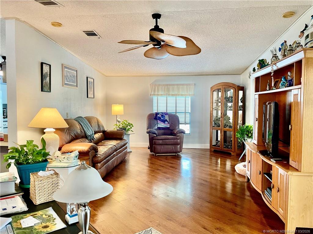 14524 Southwest Rake Drive Indiantown, FL 34956 - Photo 7 of 24 a living room with furniture and a flat screen tv
