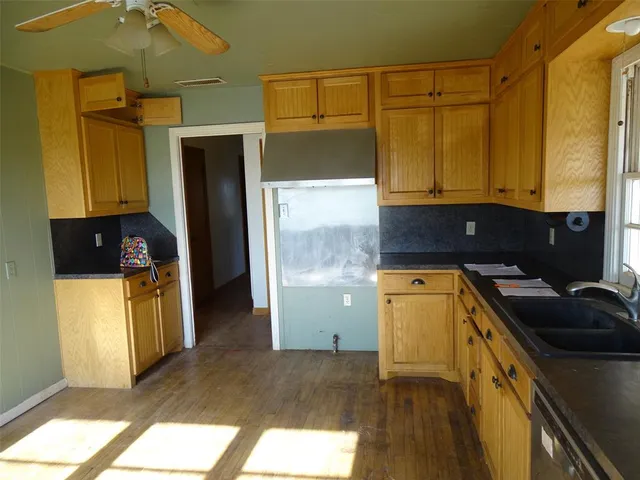 a kitchen with a sink and refrigerator