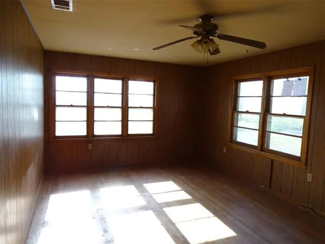 a view of room with a ceiling fan and a window
