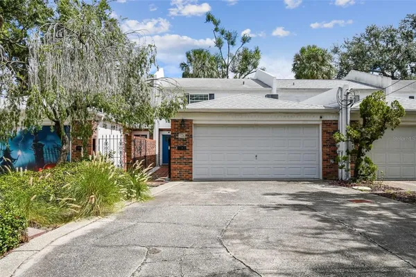a view of a house with a yard and garage