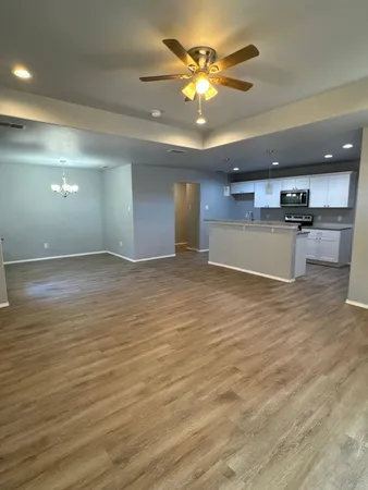 a view of a kitchen with a sink and a large window