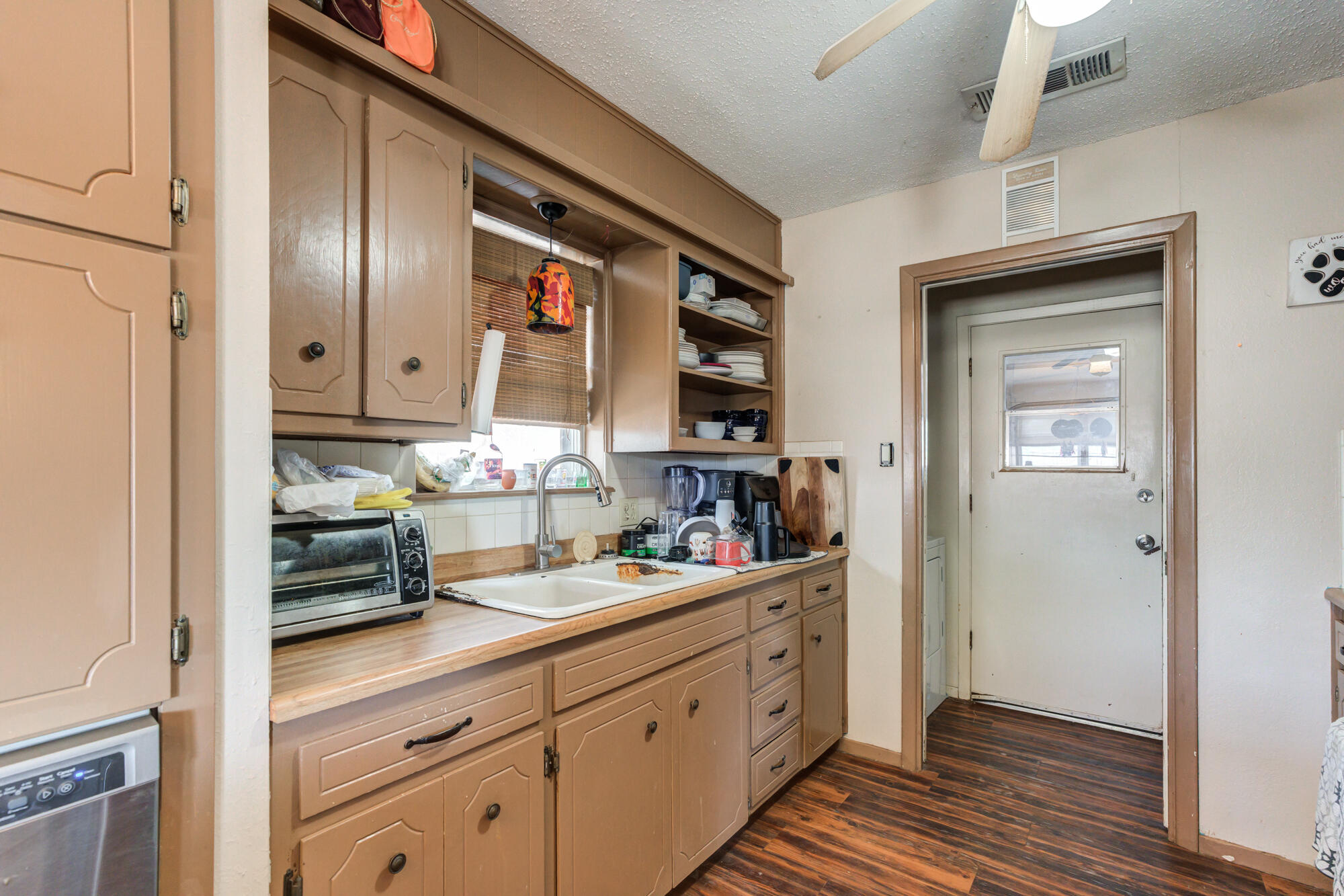 4802 53rd Street Lubbock, TX 79414 - Photo 11 of 31 a kitchen with cabinets and window