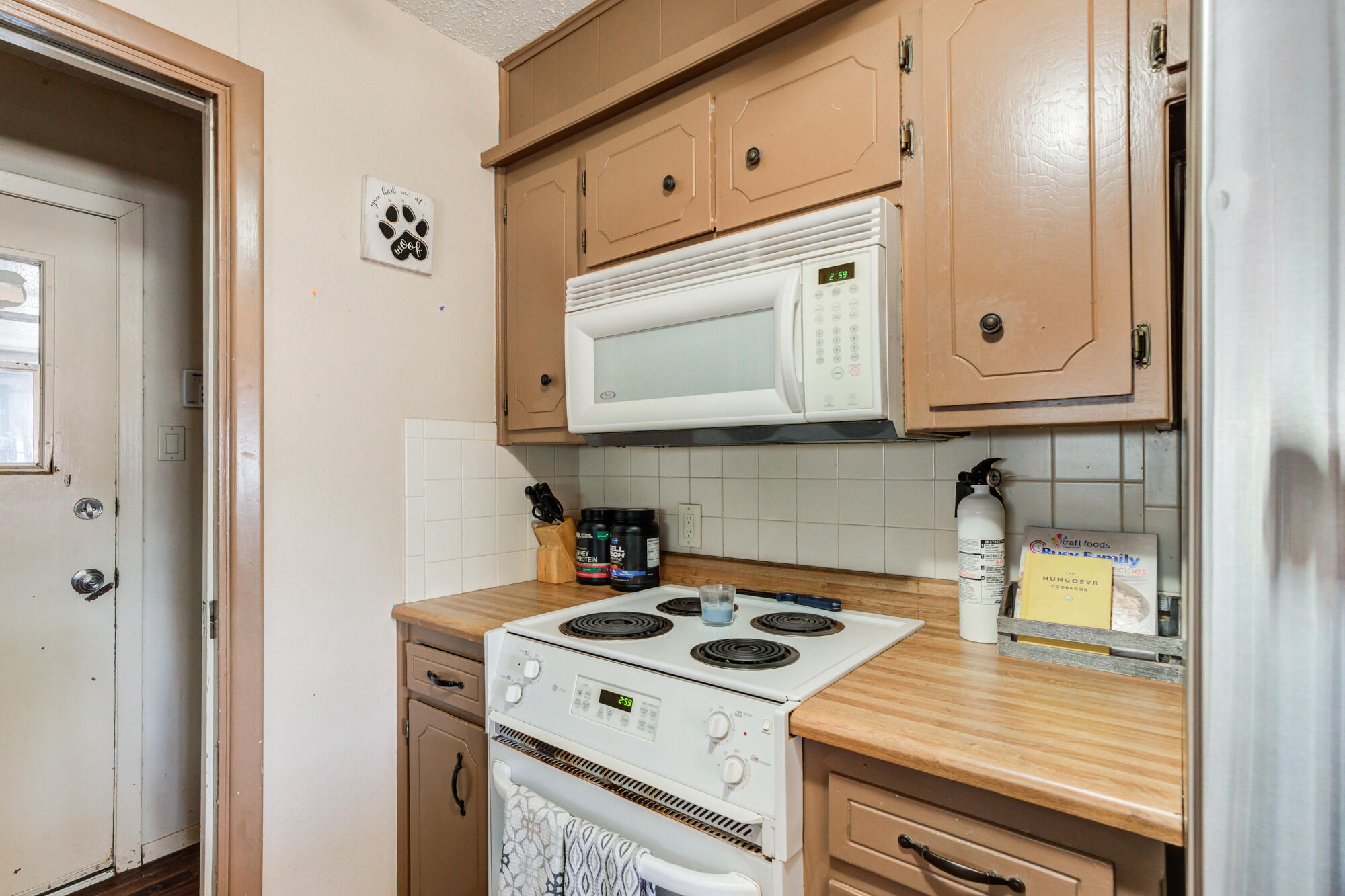 4802 53rd Street Lubbock, TX 79414 - Photo 12 of 31 a kitchen with a stove and a microwave