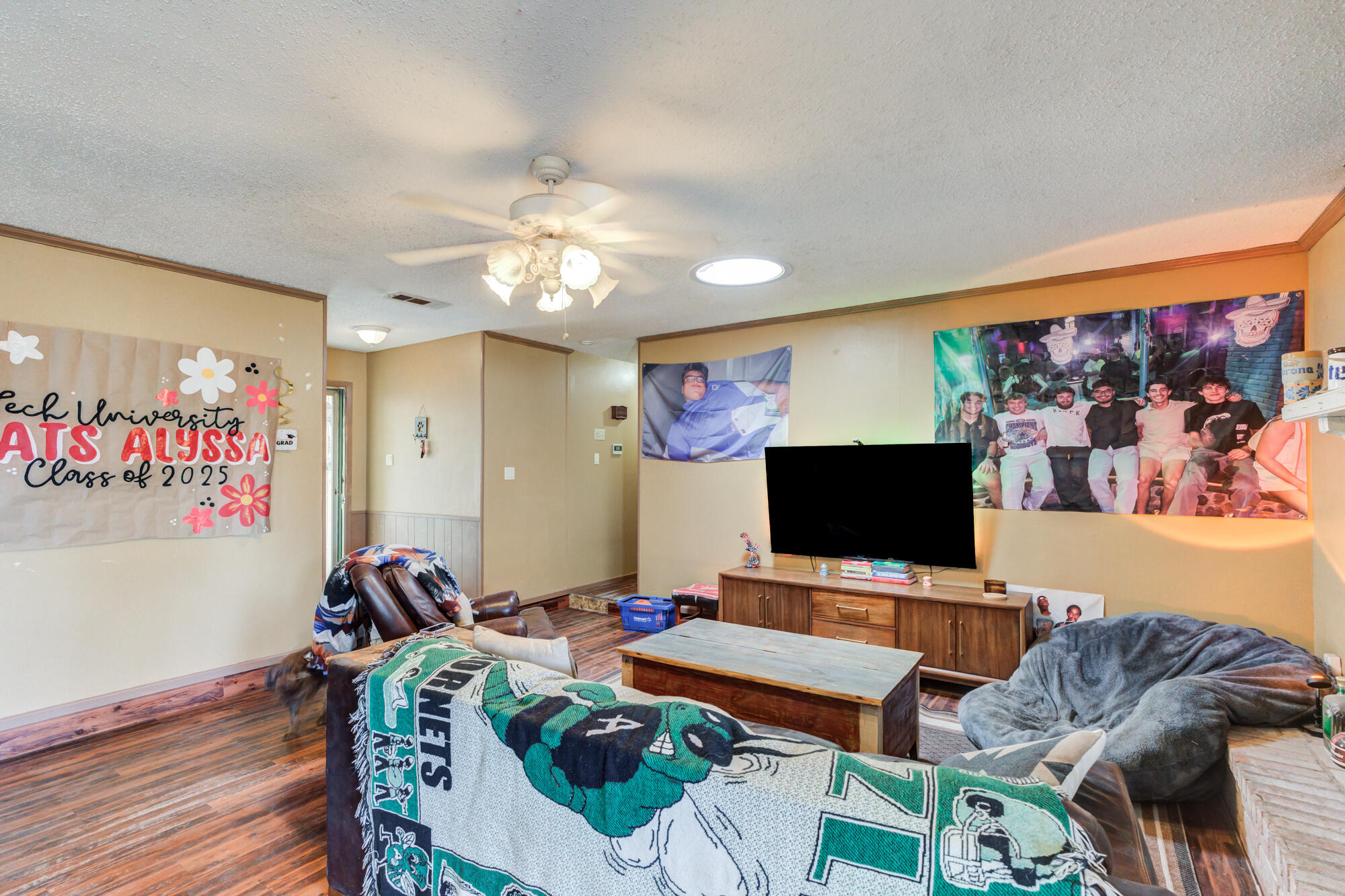 4802 53rd Street Lubbock, TX 79414 - Photo 16 of 31 a living room with furniture and a flat screen tv