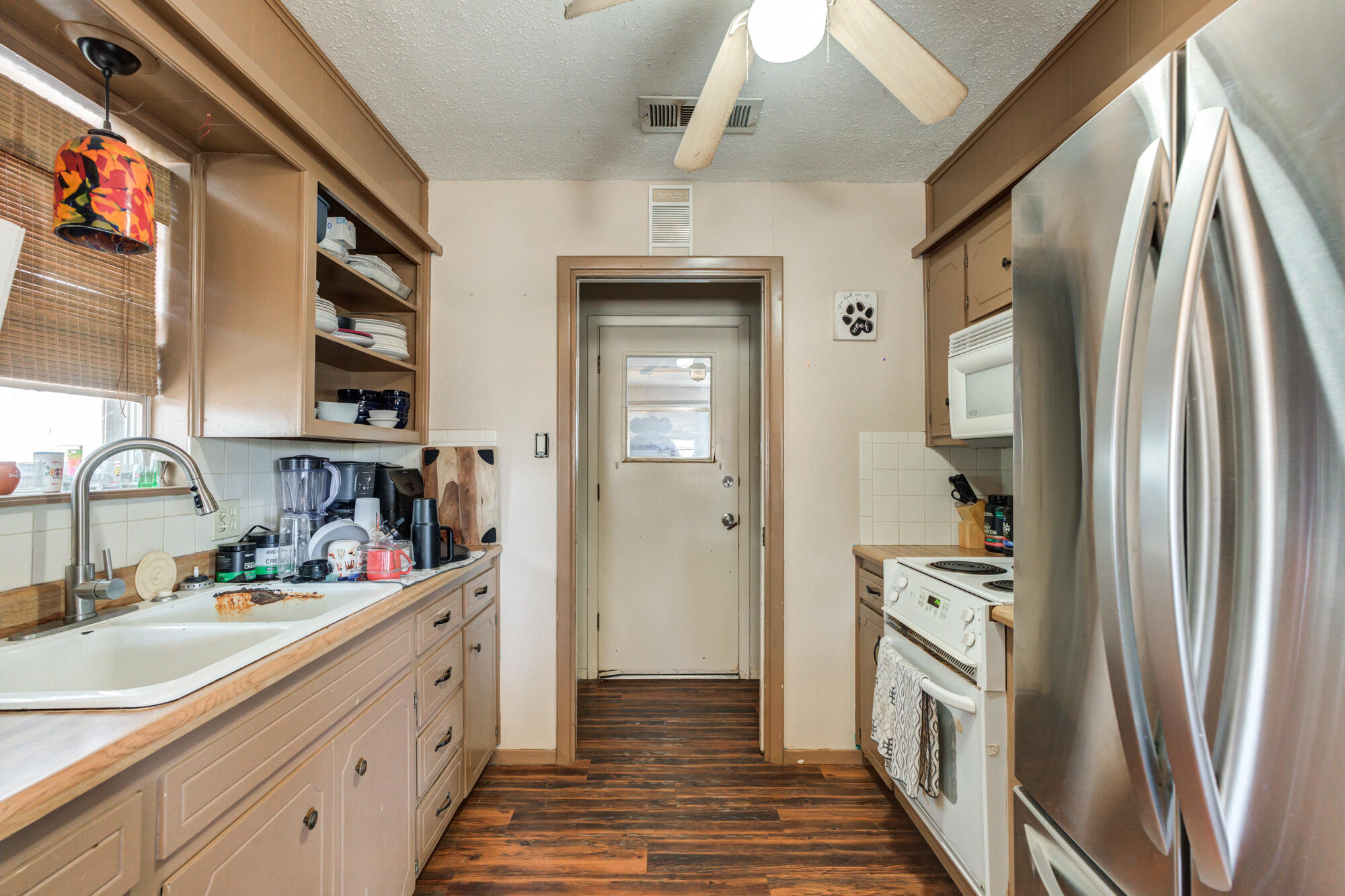 4802 53rd Street Lubbock, TX 79414 - Photo 2 of 31 a kitchen with stainless steel appliances a refrigerator and a sink