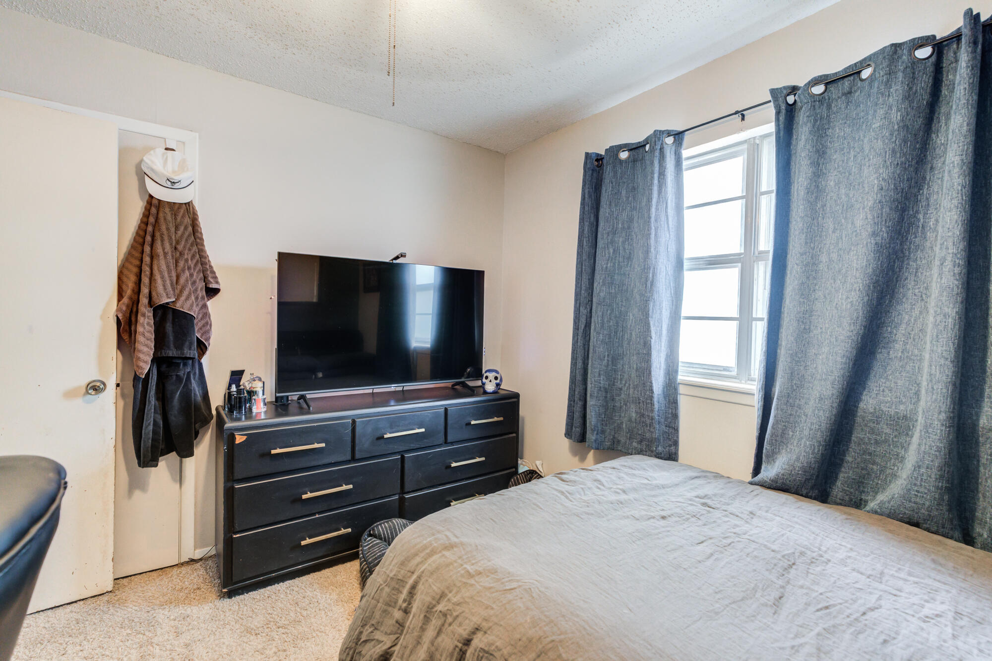 4802 53rd Street Lubbock, TX 79414 - Photo 21 of 31 a bedroom with a bed and a flat screen tv