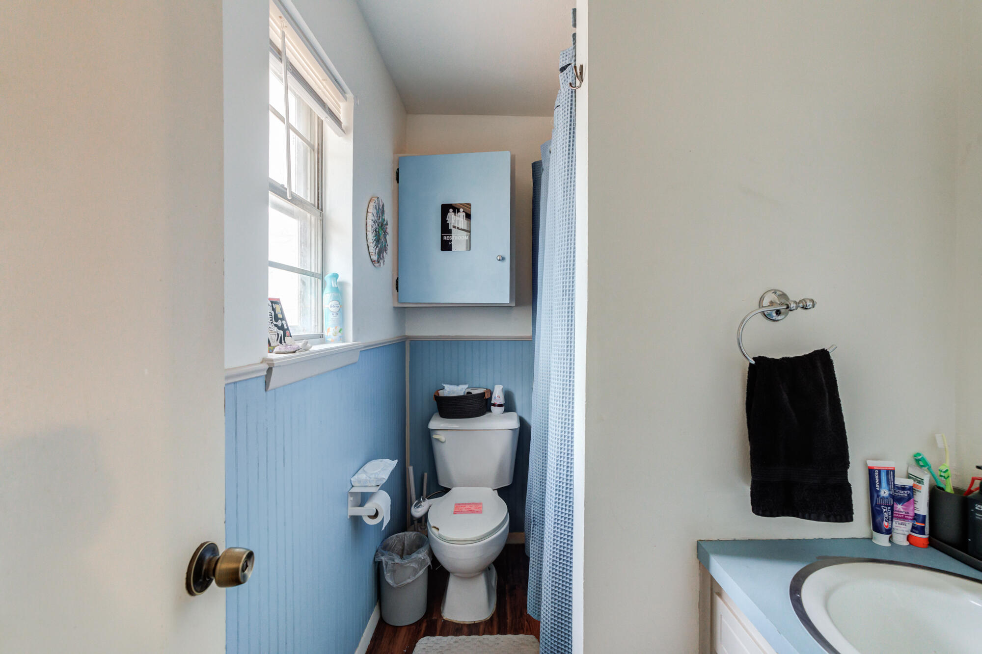 4802 53rd Street Lubbock, TX 79414 - Photo 23 of 31 a bathroom with a toilet sink and mirror