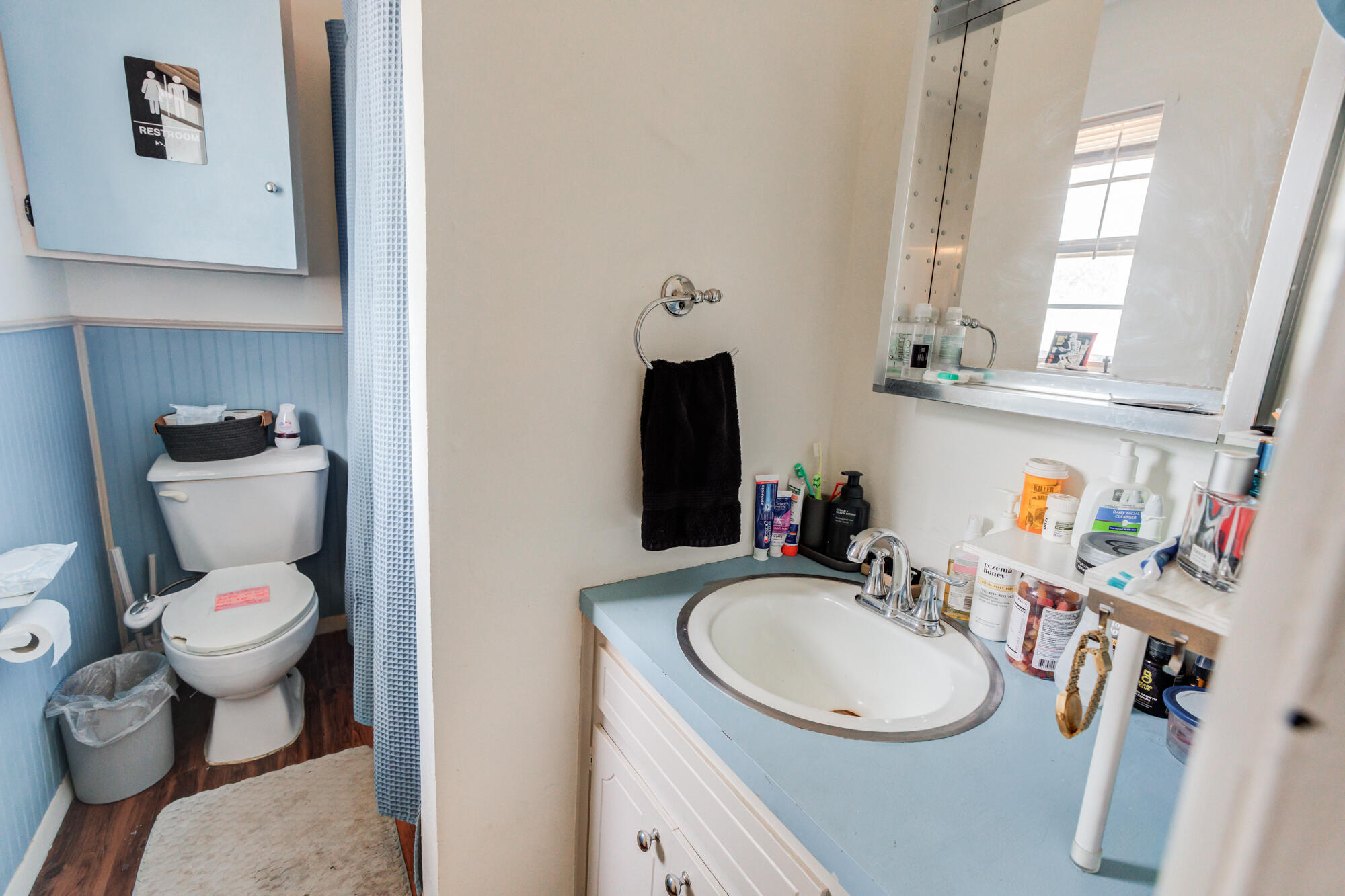 4802 53rd Street Lubbock, TX 79414 - Photo 24 of 31 a bathroom with a sink toilet mirror and vanity