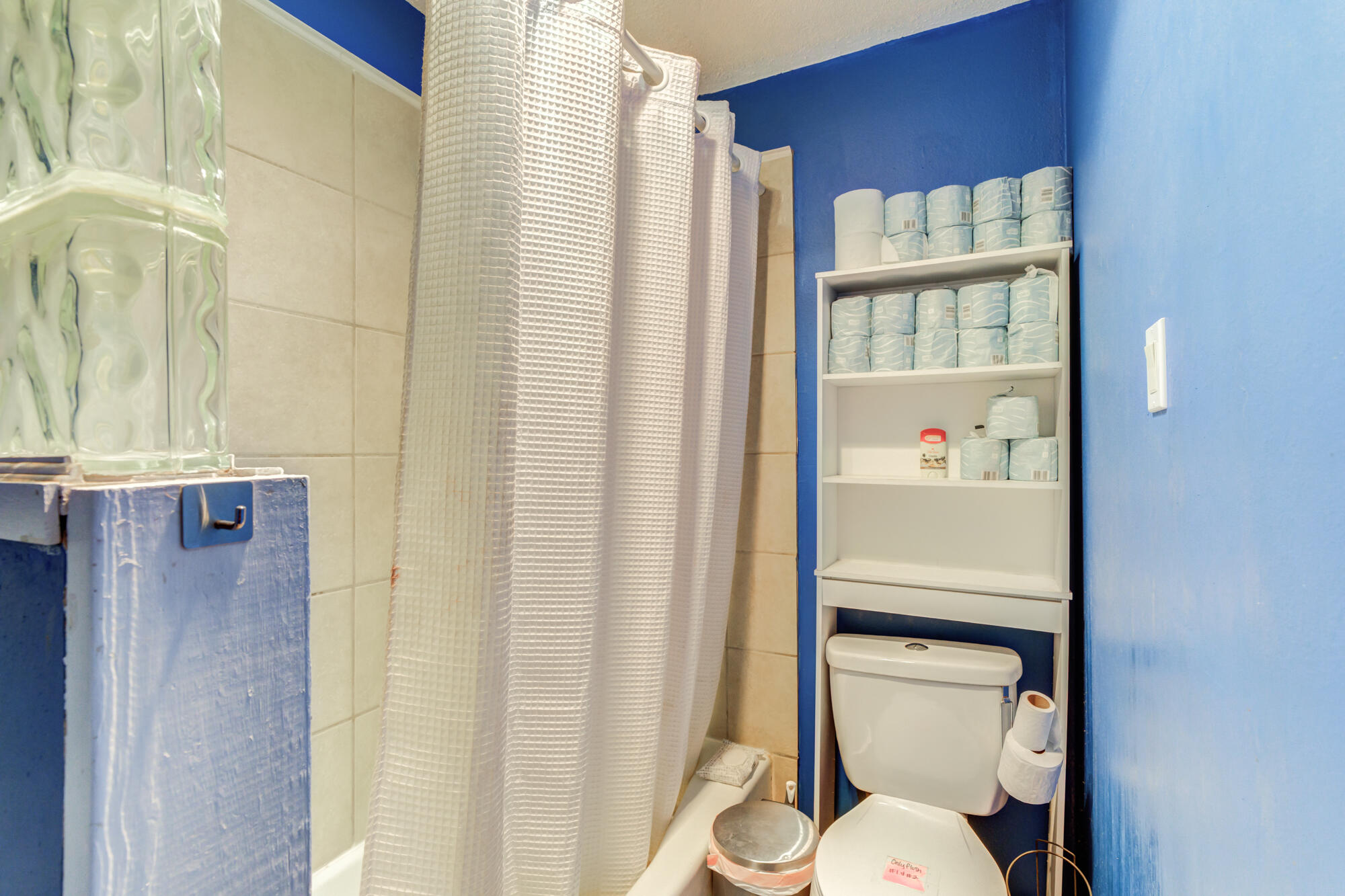 4802 53rd Street Lubbock, TX 79414 - Photo 26 of 31 a white toilet sitting next to a shower curtain