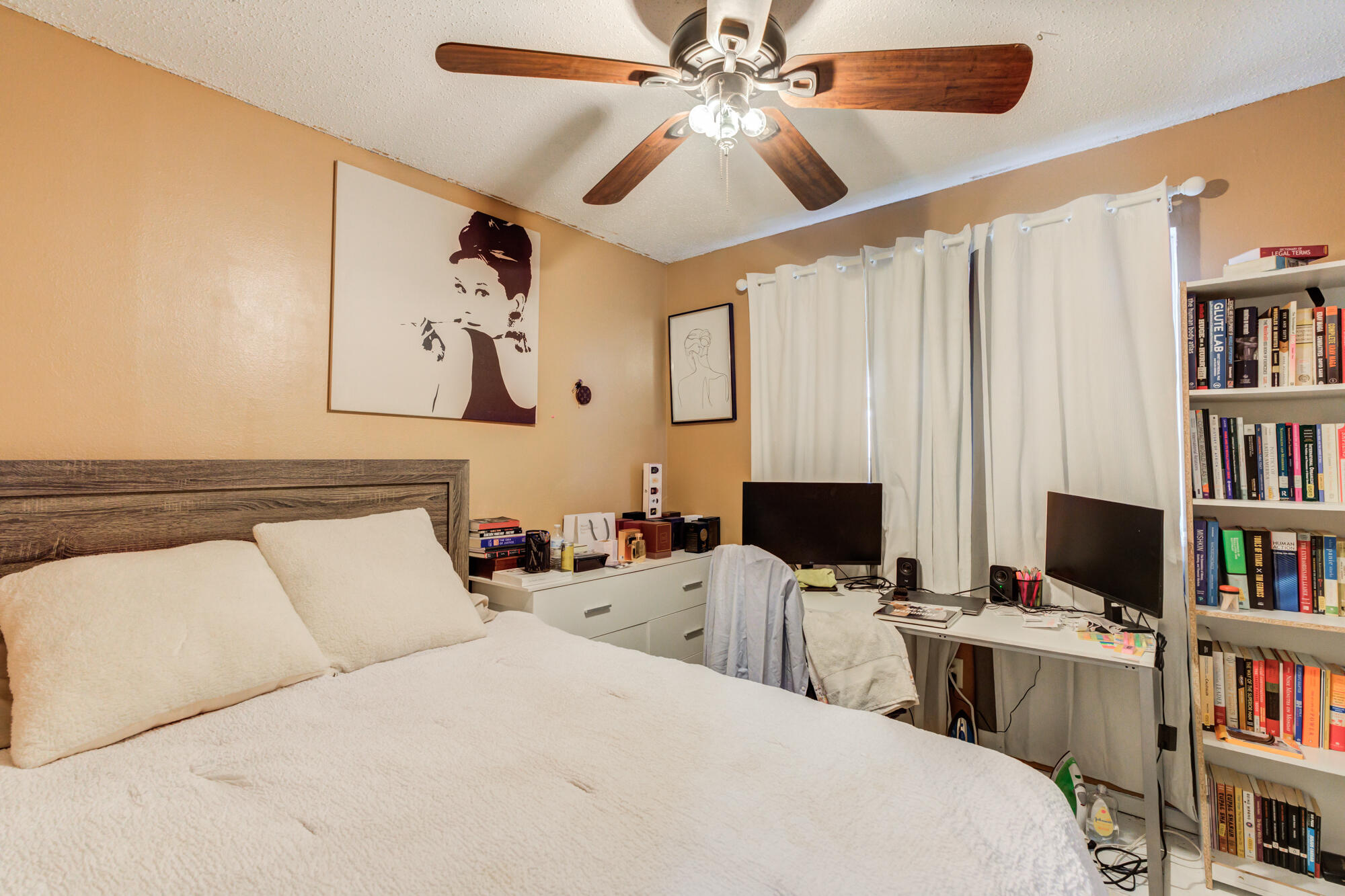 4802 53rd Street Lubbock, TX 79414 - Photo 27 of 31 a room with a bed and a bookshelf