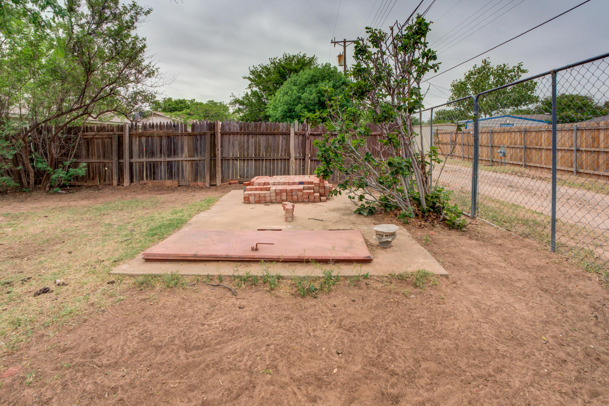 4802 53rd Street Lubbock, TX 79414 - Photo 31 of 31 a view of a backyard with a small cabin
