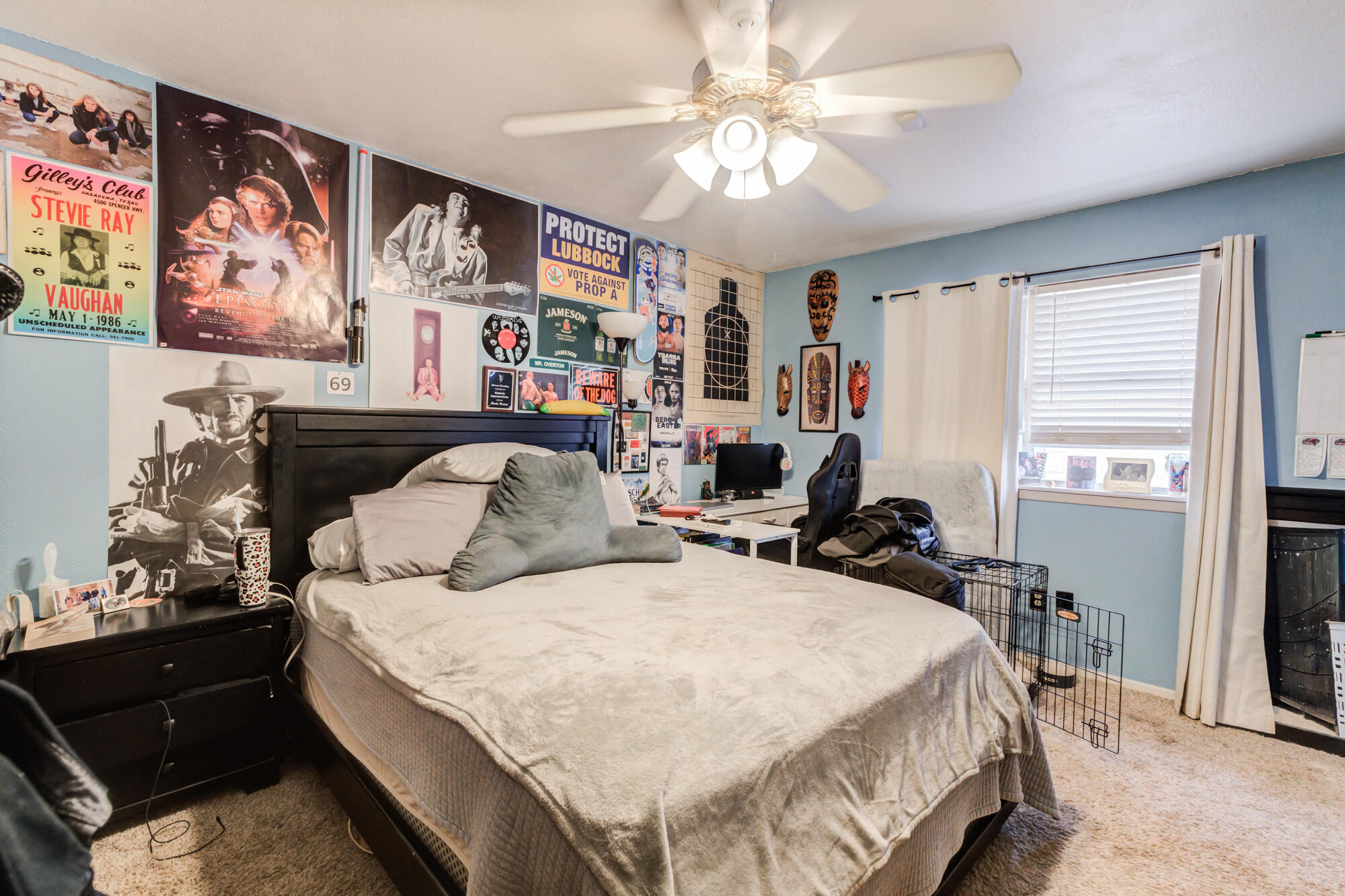 4802 53rd Street Lubbock, TX 79414 - Photo 4 of 31 a bedroom with a bed and a chandelier