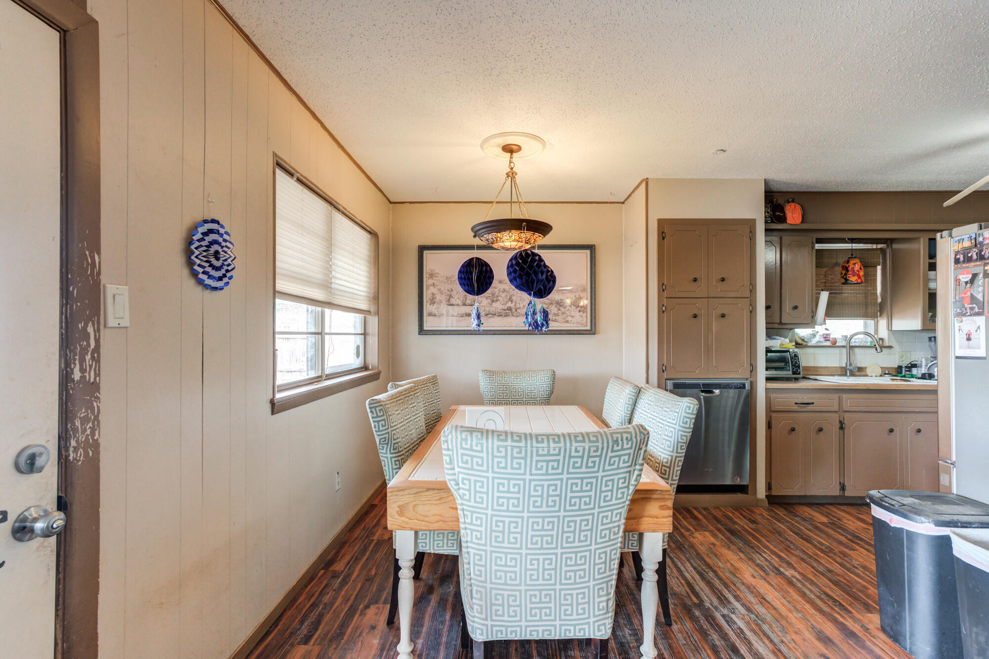 4802 53rd Street Lubbock, TX 79414 - Photo 10 of 31 a view of a dining room with furniture window and wooden floor