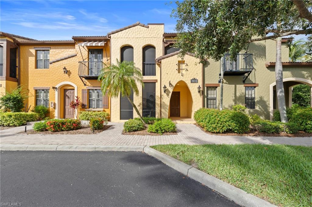 9076 Rialto Street, Unit 6204 Naples, FL 34113 - Photo 3 of 50 Mediterranean-style condos with stucco exterior, arched entryways, and decorative iron balconies. NEW FRONT DOOR TOUCH KEYPAD (2026), NEW NO-SEE-UM SCREEN LANAI (2025), NEW ROOF (2024), NEW AIR CONDITIONER (2021), NEW INTERIOR PAINT THROUGHOUT (2018)