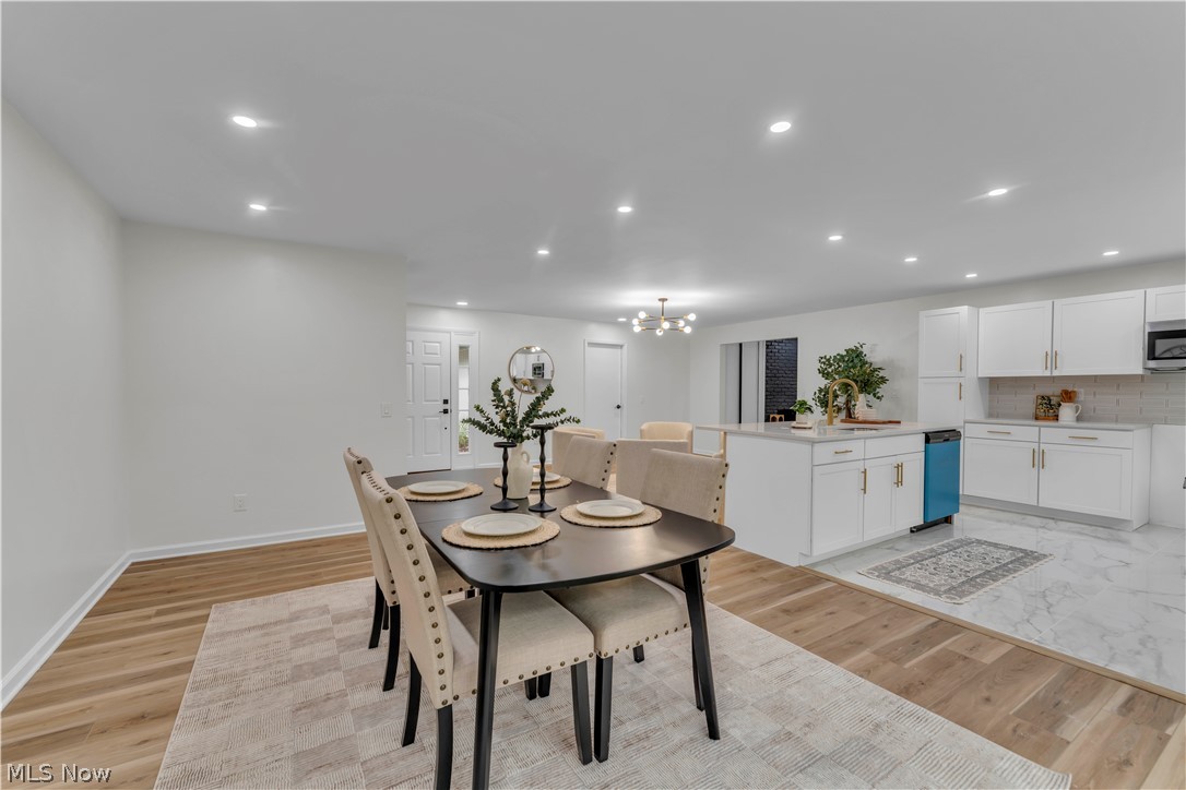 10763 Gate Post Road Strongsville, OH 44149 - Photo 22 of 45 Open-concept living space featuring wood-finish flooring, recessed lighting, and a white kitchen with an island