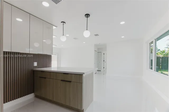 a room with a sink a mirror and shower