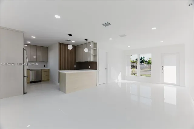 a view of a kitchen with a sink and a large window