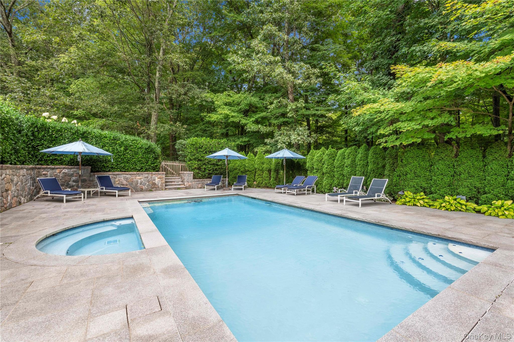 284 West Patent Road Bedford, NY 10549 - Photo 36 of 40 View of swimming pool with a patio, stairs, and a pool with connected hot tub