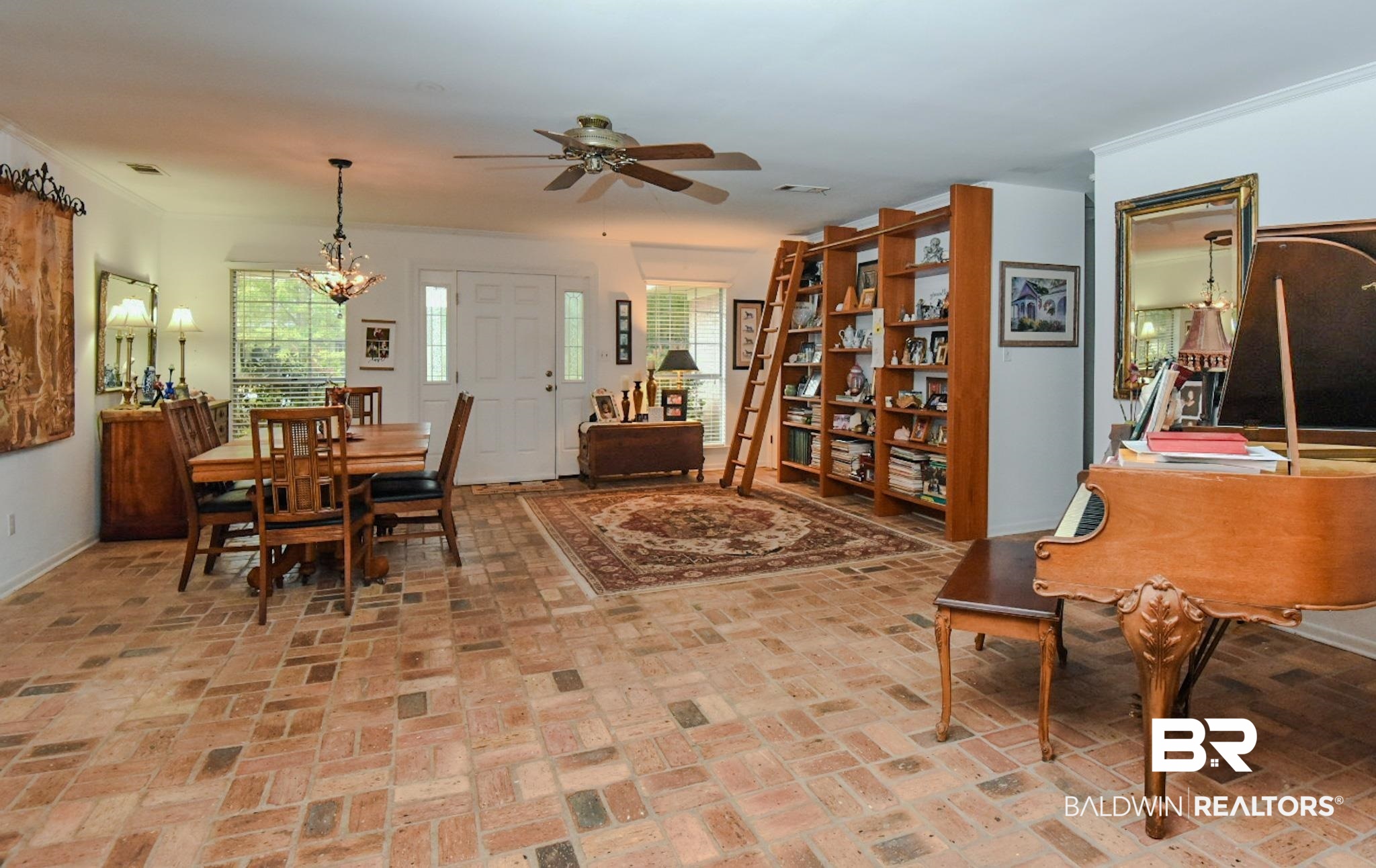 90 Paddock Drive Fairhope, AL 36532 - Photo 6 of 23 Dining area with brick floors, ornamental molding, a ceiling fan, and a chandelier