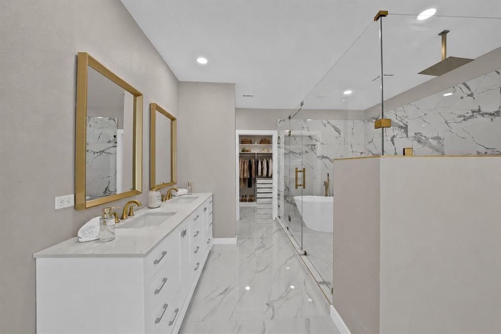 620 East 6th Street Springtown, TX 76082 - Photo 15 of 40 a spacious bathroom with a double vanity sink mirror and shower