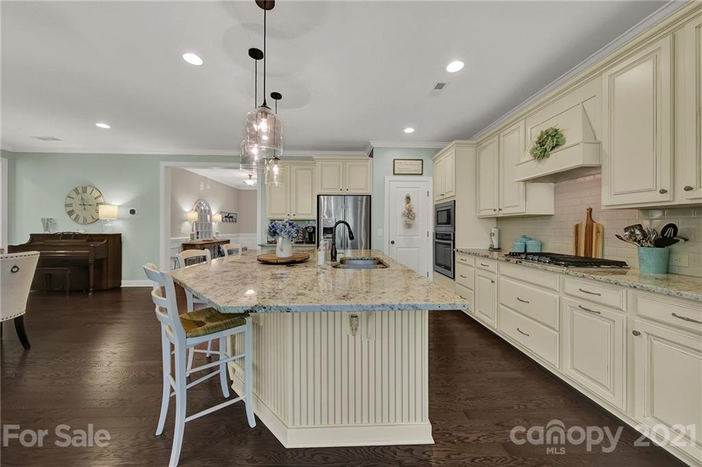 1033 Emory Lane Fort Mill, SC 29708 - Photo 13 of 48 a kitchen with kitchen island granite countertop a large center island a sink and a stove