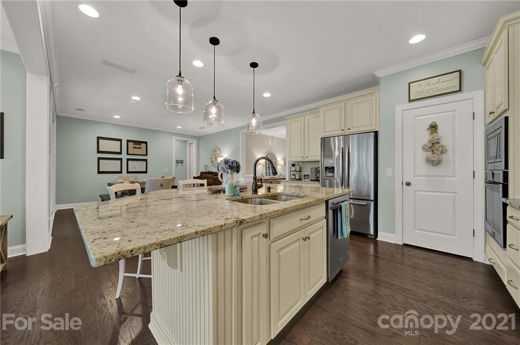 1033 Emory Lane Fort Mill, SC 29708 - Photo 14 of 48 a kitchen with stainless steel appliances granite countertop a refrigerator a sink dishwasher and a stove with wooden floor
