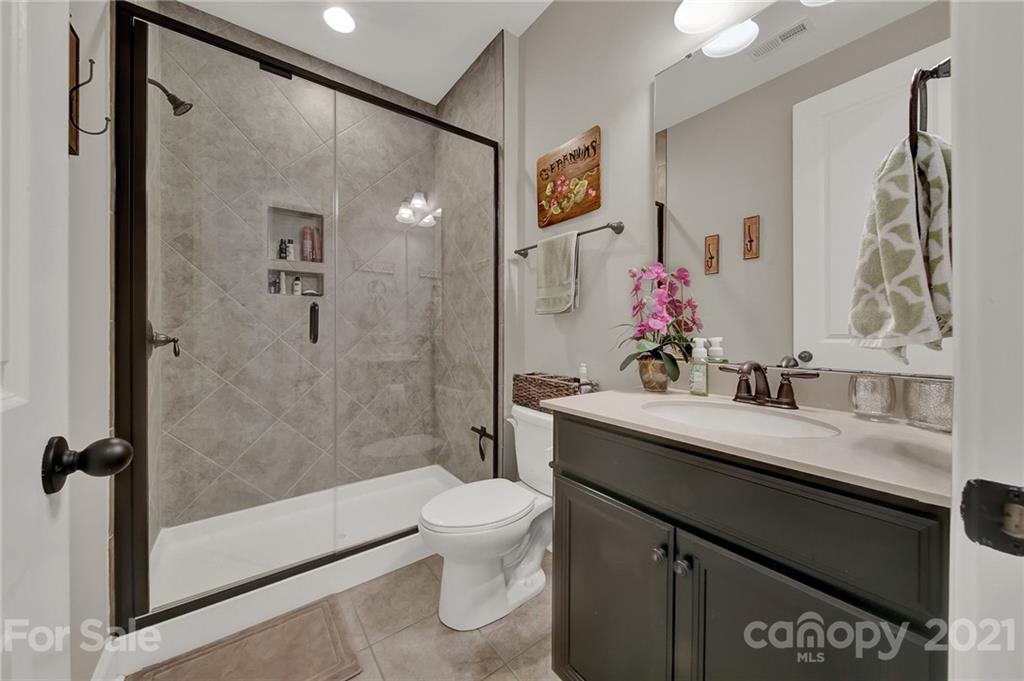 1033 Emory Lane Fort Mill, SC 29708 - Photo 20 of 48 a bathroom with a granite countertop sink mirror toilet and shower