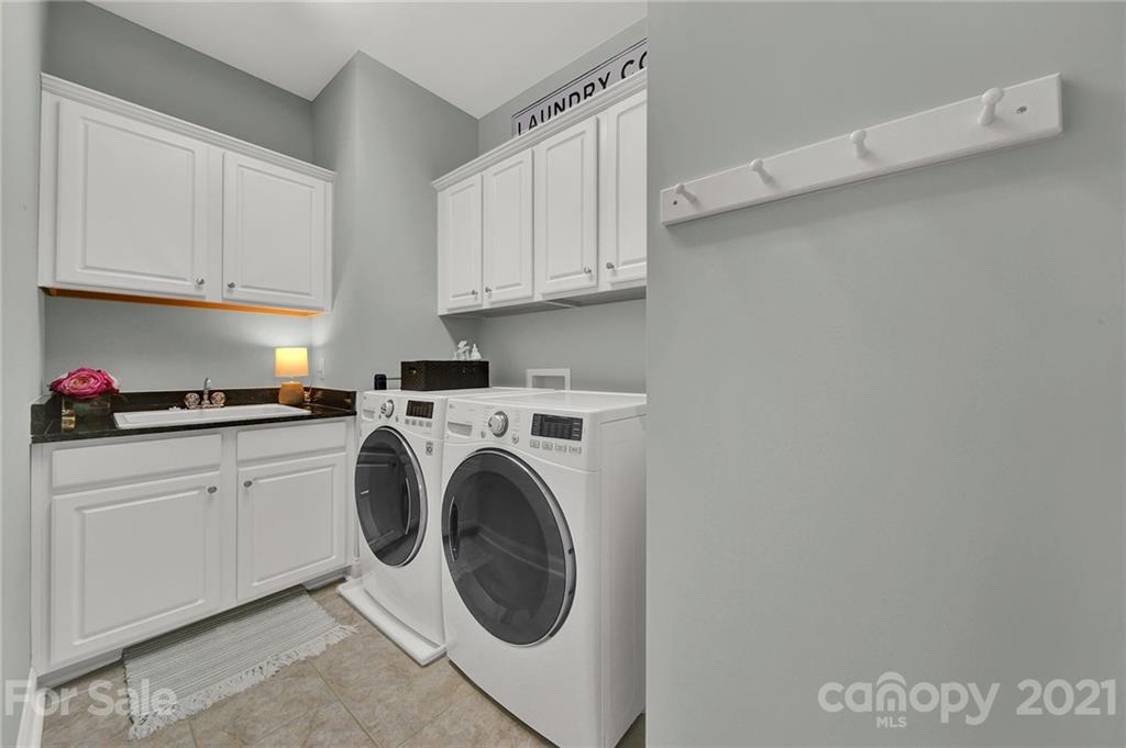 1033 Emory Lane Fort Mill, SC 29708 - Photo 30 of 48 a kitchen with cabinets and washer